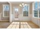 Bright dining area featuring light hardwood floors, chandelier, and ample natural light from three large windows at 1060 Fairhaven Dr # 96, Mebane, NC 27302