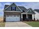 Inviting brick home with a two-car garage, a covered front porch and gabled roofline at 1060 Fairhaven Dr # 96, Mebane, NC 27302