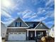 Charming new construction home featuring a brick facade, attached two-car garage, and well-manicured lawn at 1060 Fairhaven Dr # 96, Mebane, NC 27302