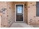 This home has a covered entry with a black front door with glass and sidelight framed by brick at 1060 Fairhaven Dr # 96, Mebane, NC 27302
