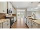 Well-lit kitchen with stainless steel appliances, backsplash, and spacious island at 1060 Fairhaven Dr # 96, Mebane, NC 27302