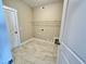 Tiled laundry room with hookups, door, and one wire shelf on the wall at 1060 Fairhaven Dr # 96, Mebane, NC 27302