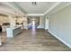 Open-concept living area showcasing a kitchen island, hardwood floors, and natural light at 1060 Fairhaven Dr # 96, Mebane, NC 27302