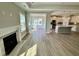 Open-concept living room with fireplace flows into a modern kitchen and sunlit breakfast nook at 1060 Fairhaven Dr # 96, Mebane, NC 27302