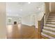 Open-concept living room with hardwood floors, fireplace and staircase at 1060 Fairhaven Dr # 96, Mebane, NC 27302