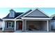 Charming home with gray siding, a brick-accented garage, and a welcoming red front door at 180 Brunswick Dr, Nashville, NC 27856