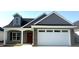 Charming new home with a two-car garage, brick accents, and a welcoming covered front porch at 180 Brunswick Dr, Nashville, NC 27856
