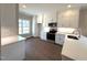 Bright kitchen featuring white cabinetry, stainless steel appliances, hardwood floors and an island with stone countertops at 180 Brunswick Dr, Nashville, NC 27856