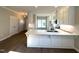 Kitchen featuring white cabinets, stainless steel appliances, hardwood floors and a large island with stone countertops at 180 Brunswick Dr, Nashville, NC 27856