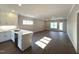Open concept floor plan featuring kitchen with white cabinets and spacious living room with hardwood floors and ample natural light at 180 Brunswick Dr, Nashville, NC 27856