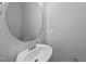 Simple bathroom with a round mirror and white sink at 20 Nettle Ln # 239, Clayton, NC 27520