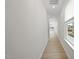 Bright hallway with light hardwood floors and neutral walls at 20 Nettle Ln # 239, Clayton, NC 27520