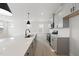 Modern kitchen with gray cabinets, stainless steel appliances, and quartz countertops at 20 Nettle Ln # 239, Clayton, NC 27520