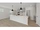Open concept kitchen with island and modern light fixtures at 20 Nettle Ln # 239, Clayton, NC 27520