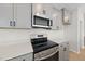 Stainless steel appliances and gray cabinets in this modern kitchen at 20 Nettle Ln # 239, Clayton, NC 27520