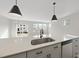 Modern kitchen features a large island with quartz countertops and stainless steel sink at 20 Nettle Ln # 239, Clayton, NC 27520
