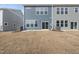 Rear view of townhome showcasing patio and landscaping at 20 Nettle Ln # 239, Clayton, NC 27520