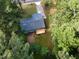 Aerial view showcases the home, deck, and expansive, tree-lined property at 2704 Ross Rd, Durham, NC 27703