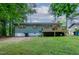 Spacious backyard featuring a wood deck, lush green lawn, and mature trees at 2704 Ross Rd, Durham, NC 27703
