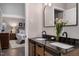 The ensuite bathroom features a granite countertop with dual undermount sinks at 2704 Ross Rd, Durham, NC 27703