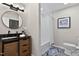 A well-lit bathroom with modern fixtures including a vanity with marble countertop and stylish mirror at 2704 Ross Rd, Durham, NC 27703