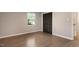 A bright bedroom with hardwood floors and a built-in closet with sliding doors at 2704 Ross Rd, Durham, NC 27703