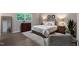 This bedroom features hardwood floors, a large window, and decorative wall mirrors at 2704 Ross Rd, Durham, NC 27703