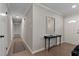 Bright entryway featuring hardwood floors, a console table, and access to other rooms at 2704 Ross Rd, Durham, NC 27703