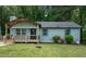 Charming single-story home with a welcoming front porch and fresh green siding at 2704 Ross Rd, Durham, NC 27703