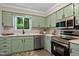 Updated kitchen with stainless steel appliances, modern backsplash, and natural light at 2704 Ross Rd, Durham, NC 27703