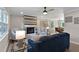 Open-concept living room with hardwood floors, fireplace, and dining area view at 2704 Ross Rd, Durham, NC 27703