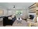 Cozy living room with a decorative fireplace, comfortable seating, and a ceiling fan at 2704 Ross Rd, Durham, NC 27703