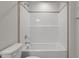 Bright bathroom featuring a white tiled shower and modern fixtures at 585 Husketh Rd, Youngsville, NC 27596