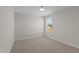 Cozy bedroom with neutral carpet, a bright window, and ample natural light at 585 Husketh Rd, Youngsville, NC 27596