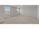 Spacious bedroom with neutral carpet and two large windows offering natural light at 585 Husketh Rd, Youngsville, NC 27596