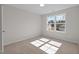 Sunlit bedroom with carpet, a large window and natural lighting at 585 Husketh Rd, Youngsville, NC 27596