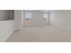 Spacious carpeted bedroom featuring two windows allowing for natural light at 585 Husketh Rd, Youngsville, NC 27596
