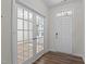 The foyer has wood flooring, an entry door, and french doors that open to a spacious room at 585 Husketh Rd, Youngsville, NC 27596