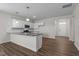 Open-concept kitchen with a large island, granite countertops, and stainless steel appliances at 585 Husketh Rd, Youngsville, NC 27596
