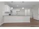 Clean, well-lit kitchen featuring a large island with granite countertops and pendant lighting at 585 Husketh Rd, Youngsville, NC 27596