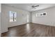 Spacious living room with hardwood flooring, a ceiling fan, and plenty of natural light at 585 Husketh Rd, Youngsville, NC 27596