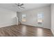 Bright living room featuring hardwood floors, a ceiling fan, and a stairway to the upper level at 585 Husketh Rd, Youngsville, NC 27596