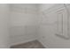 Walk-in closet with carpet, wire shelves and a white metal electrical panel at 585 Husketh Rd, Youngsville, NC 27596