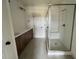 Modern bathroom with dual vanity, a glass-enclosed shower, and tile flooring at 6040 Scalybark Road, Durham, NC 27712
