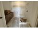 Bright bathroom featuring a tiled shower with built-in seat at 6040 Scalybark Road, Durham, NC 27712