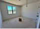 A bedroom is light-filled from a window overlooking green trees at 6040 Scalybark Road, Durham, NC 27712
