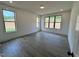 Bright and airy bedroom featuring hardwood floors, recessed lighting, and large windows with scenic views at 6040 Scalybark Road, Durham, NC 27712