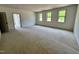 Expansive bonus room with three large windows and neutral carpeting, perfect for entertaining at 6040 Scalybark Road, Durham, NC 27712