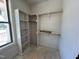 A custom closet features wood rods and shelving, with a large window offering a bright space at 6040 Scalybark Road, Durham, NC 27712