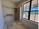 A custom closet features wood rods, shelving and large window with lots of natural light at 6040 Scalybark Road, Durham, NC 27712